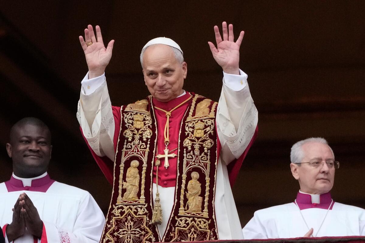 Pope Leo XIV waves after delivering the annual Christmas blessing.