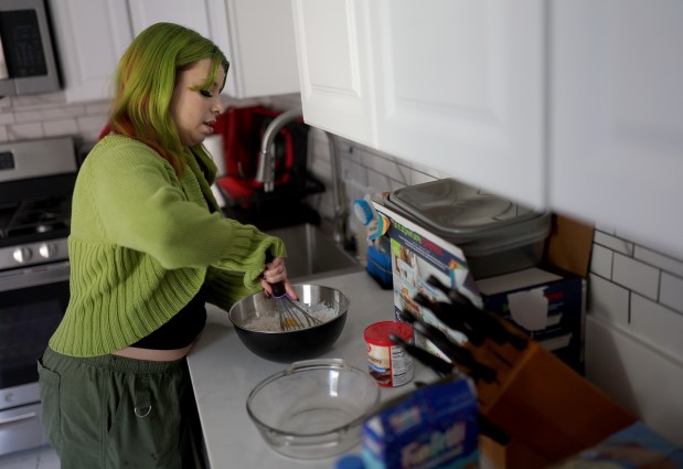 Stevie Steele, 22, bakes a cake at their new apartment in Antioch, Calif., on Thursday, Oct. 30, 2025. Steele was provided assistance by Oakland-based First Place for Youth, a nonprofit which helps transition-age foster youth. (Jane Tyska/Bay Area News Group)