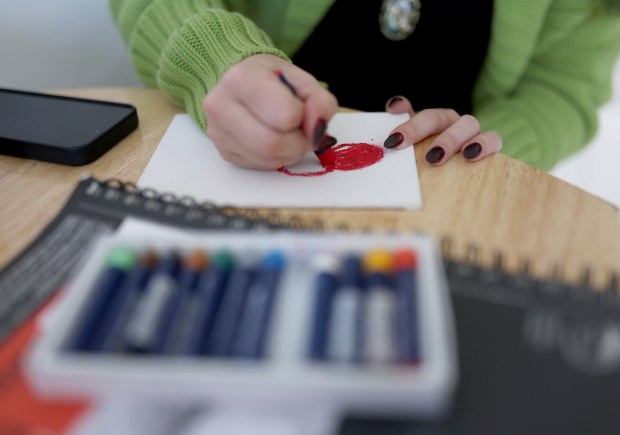 Stevie Steele, 22, a self-taught artist, draws with pastels at their new apartment in Antioch, Calif., on Thursday, Oct. 30, 2025. Steele was provided assistance by Oakland-based First Place for Youth, a nonprofit which helps transition-age foster youth. (Jane Tyska/Bay Area News Group)