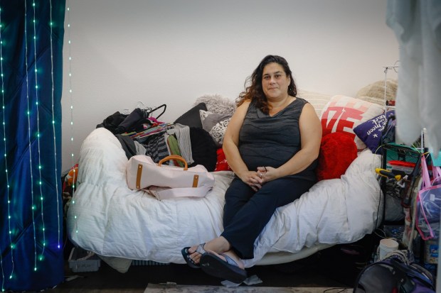 Teresa Toland, 43, sits inside her room at the tiny home village on Rue Ferrari in San Jose, Calif., on Thursday, Dec. 11, 2025. (Shae Hammond/Bay Area News Group)