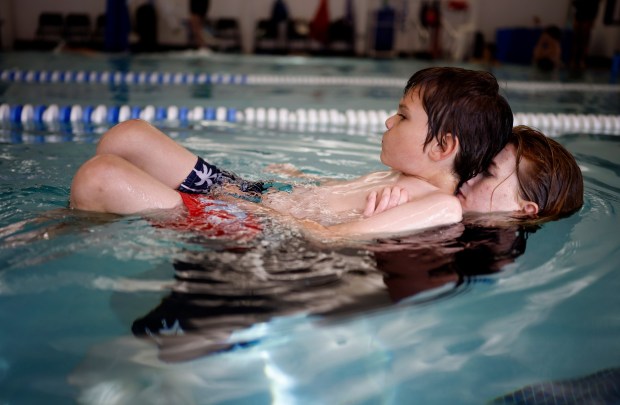 Lucas Foreman, 9, from San Jose, is taught by Natalie Hand, swim instructor, in the Safety Around Water (SAW) program at the Southwest YMCA in Saratoga, Calif., on Monday, Oct. 26, 2025. Wish Book for the YMCA Safety Around Water program. (Nhat V. Meyer/Bay Area News Group)