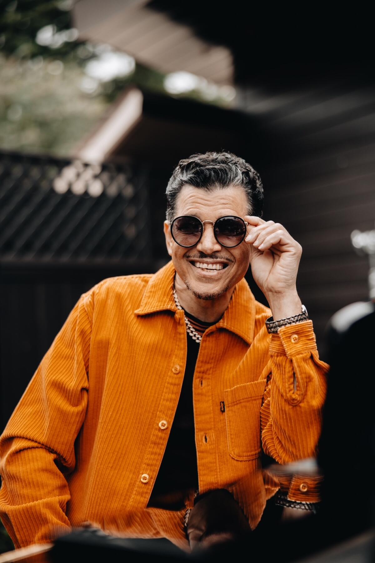 Man in sunglasses and orange jacket