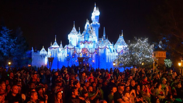 Visitors to Disneyland watch A Christmas Fantasy Parade near Sleeping Beauty Castle in 2018. (Photo by Jeff Gritchen, Orange County Register/SCNG)