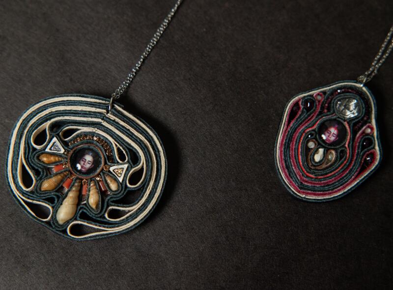 Cuban American artist Ana Mendieta sits at the center of these necklaces.