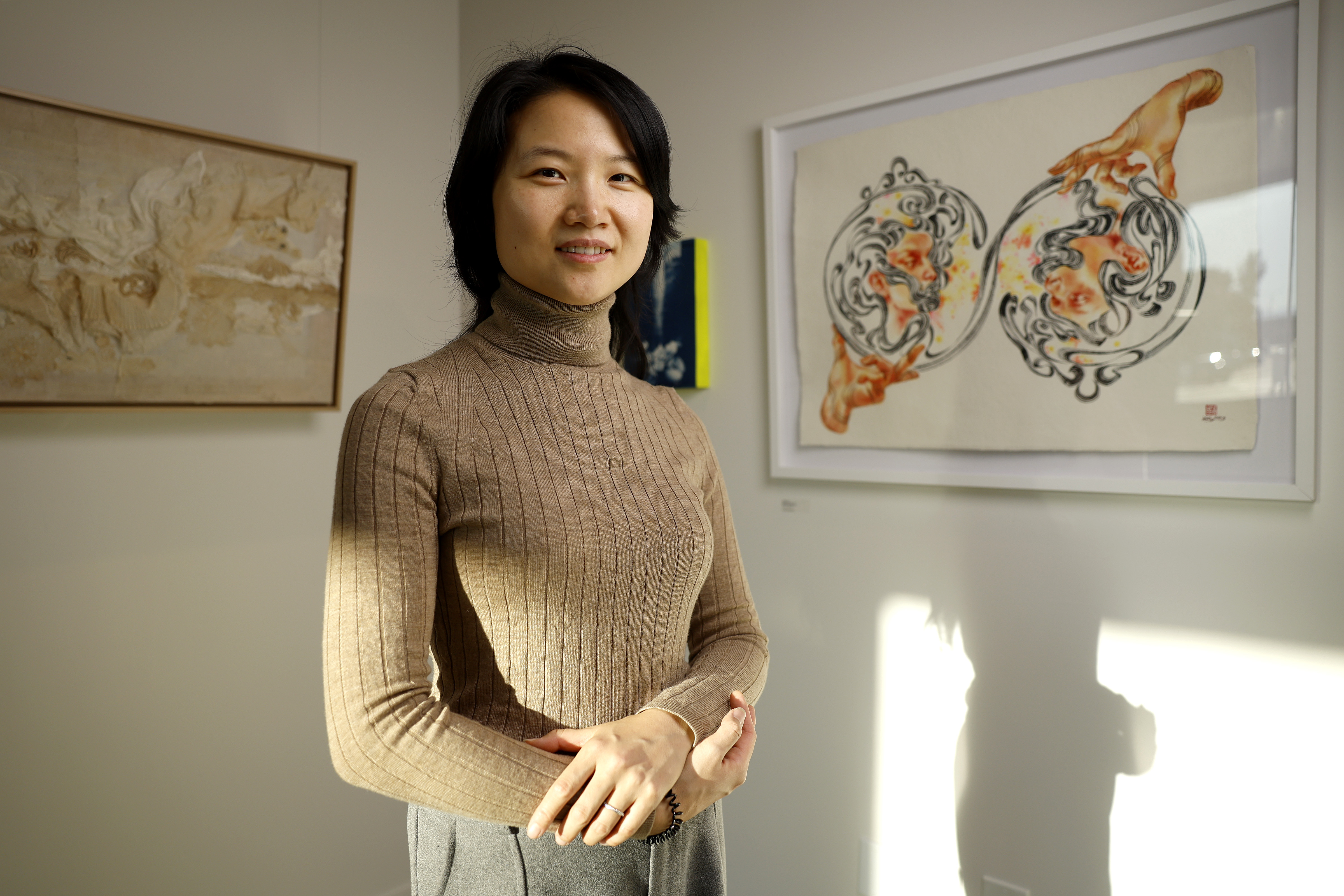 Artist Yuting Wang poses next to her artwork titled âMirror...