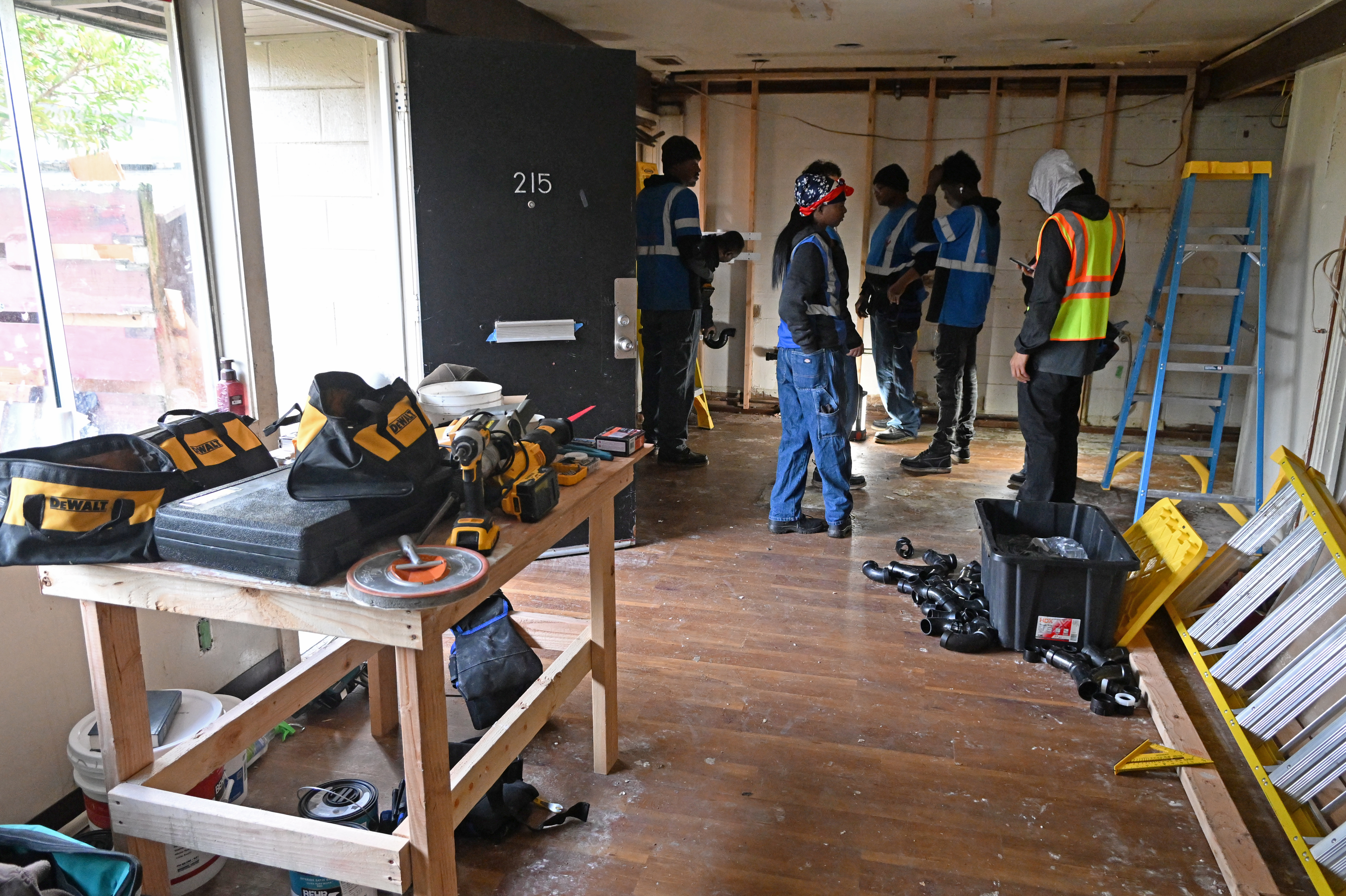 Construction trainees work in an apartment at Golden Gate Village...