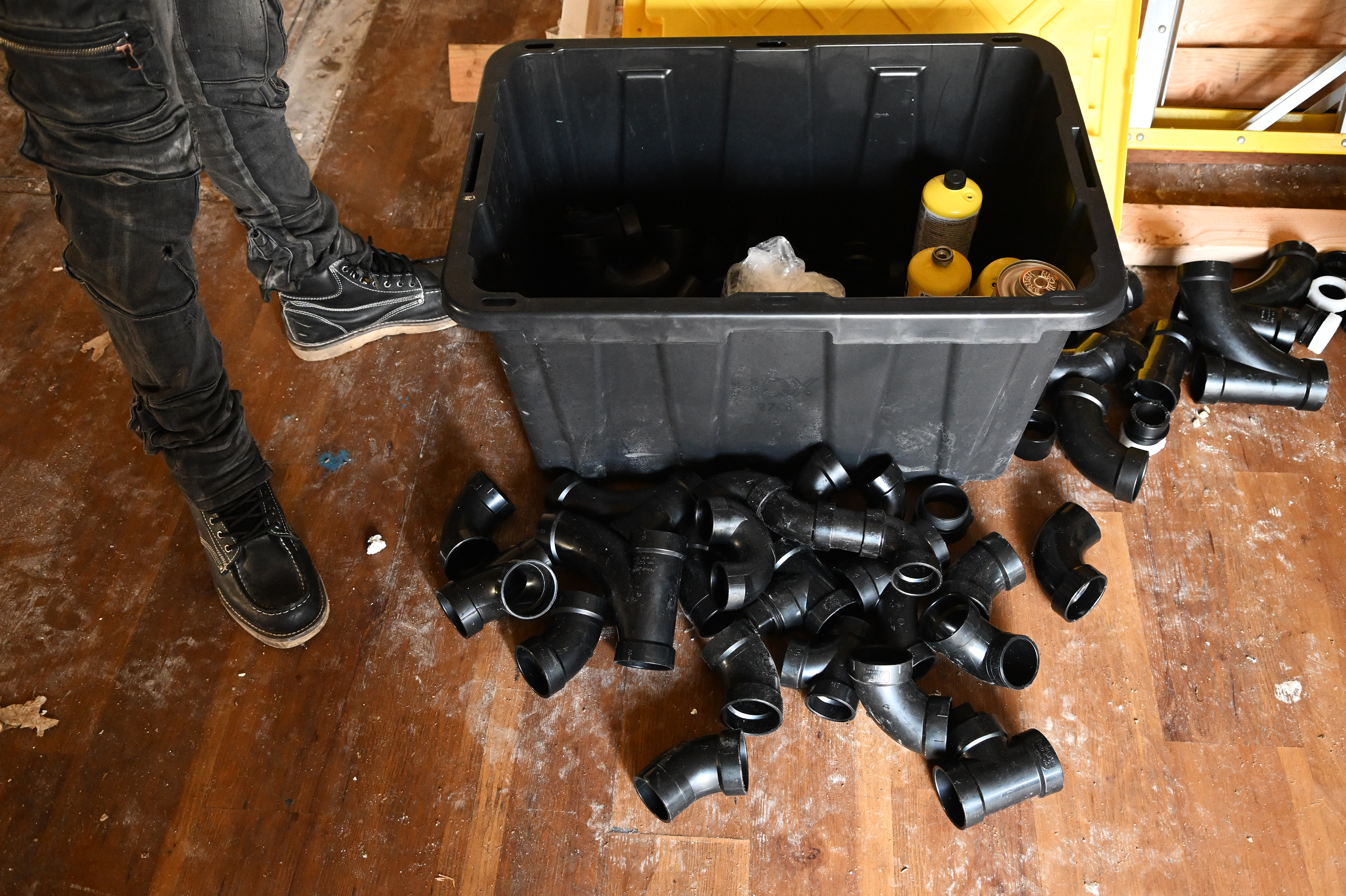 Construction supplies lie on the floor of an apartment being...
