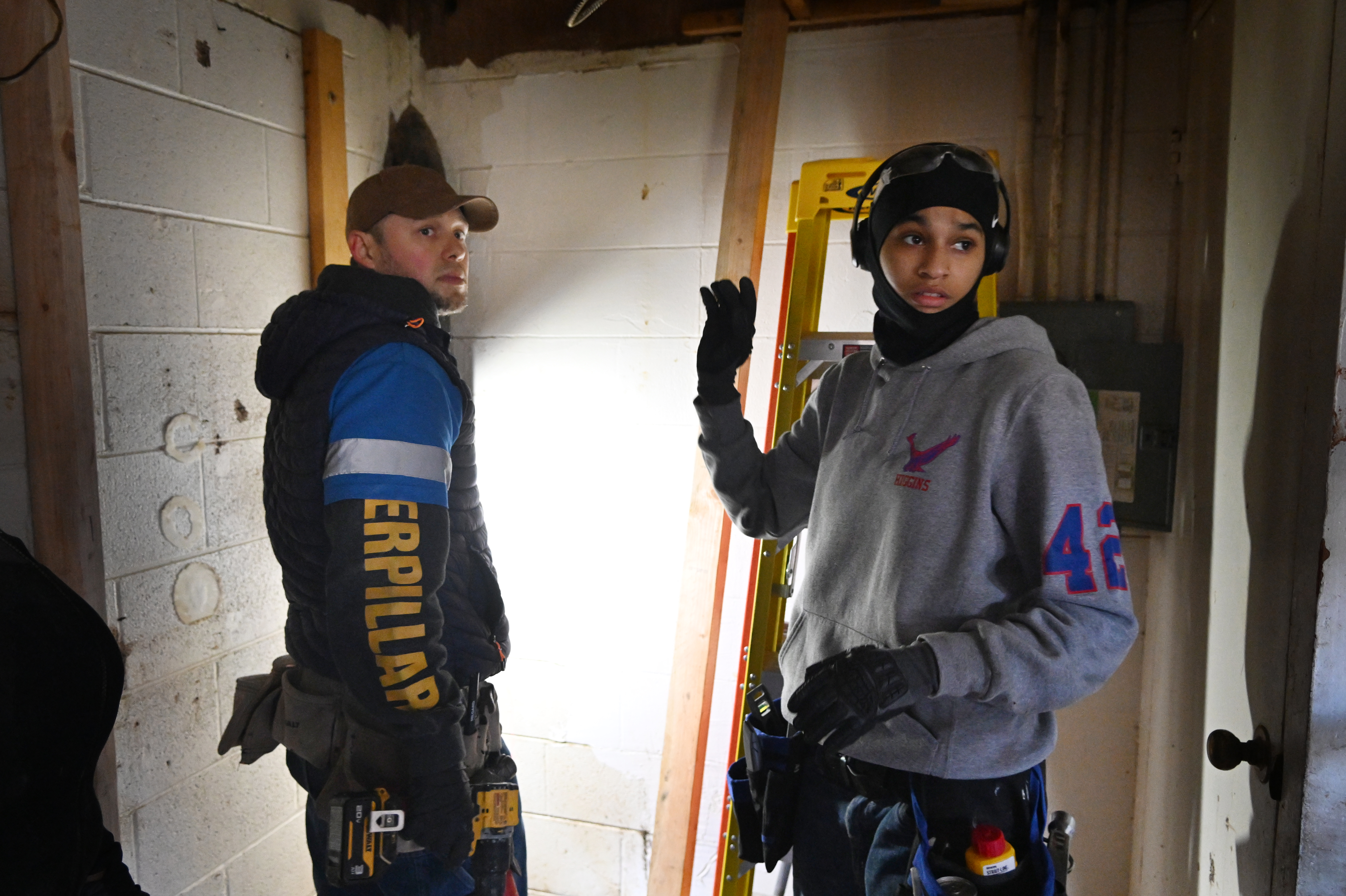 Instructor Andrey Sotnikov and trainee Sanaa Green renovate an apartment...