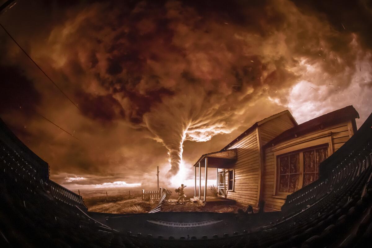 A tornado swirls on a giant movie screen.