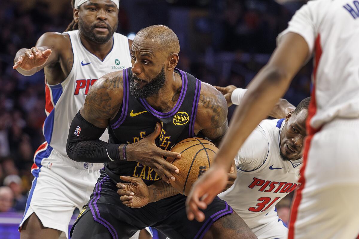 Lakers star LeBron James is fouled by Detroit Pistons guard Javonte Green (31) in the first half Tuesday.
