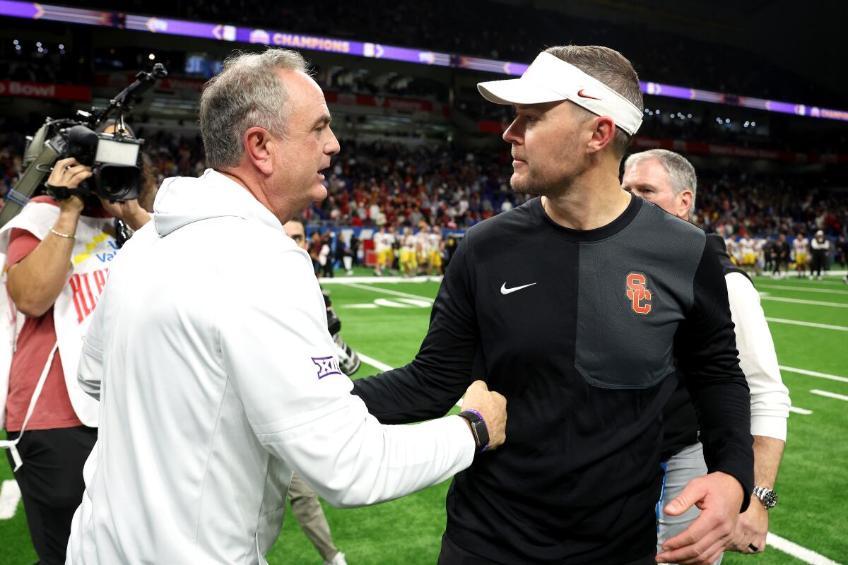 USC coach Lincoln Riley, right, shakes hands with Texas Christian coach Sonny Dykes after the Alamo Bowl