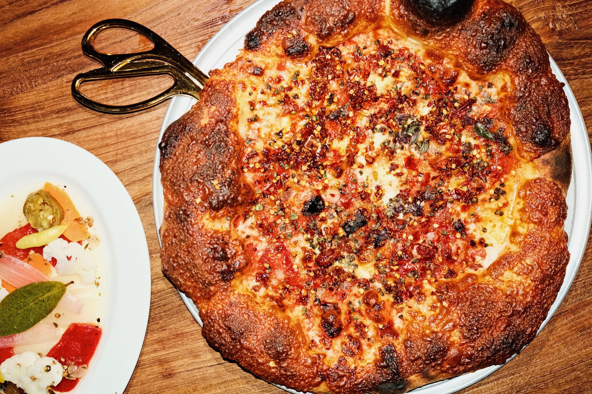 An overhead photo of the chile-flecked Hail Satan pizza at Leopardo.