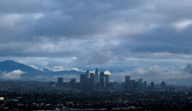 Storm clouds blanket the Los Angeles skyline is seen from Kenneth Hahn State Recreation Area on Friday, Dec. 24, 2021. (AP Photo/Ringo H.W. Chiu)