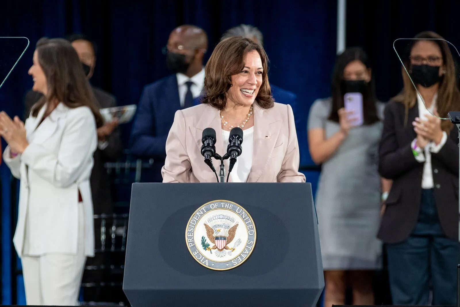 Kamala Harris standing at a podium speaking.