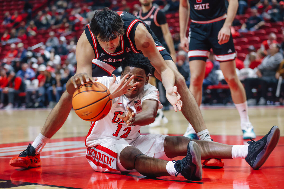 UNLV guard Issac Williamson (12) fights for possession of the ball during an NCAA basketball ga ...