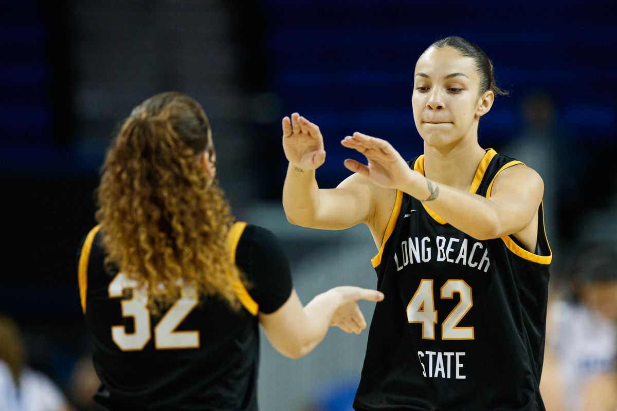Long Beach State forward Judit Oliva Fernandez (42) high fives guard Brynna Pukis (32) during an NCAA basketball game against the UCLA Bruins, Saturday December 20, 2025 in Los Angeles, Calif.