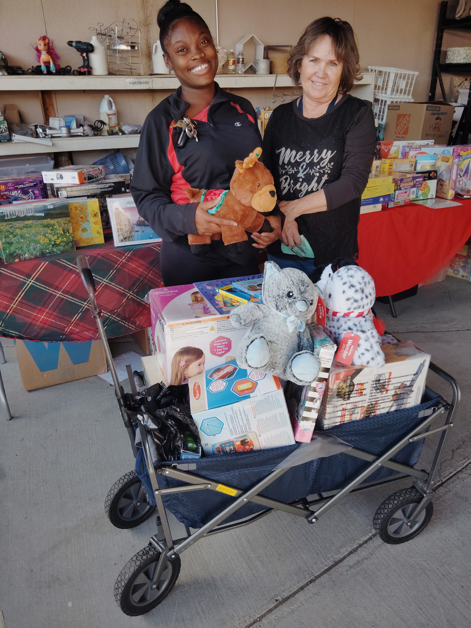Shanique Moore, a military mom, came to Share Your Christmas. She is with Lori Garrow, an RFCC board member.