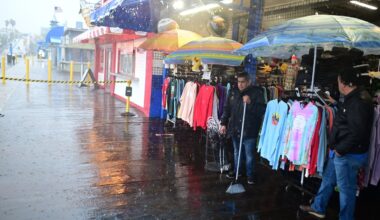 Miguel Lopez swept water from Marlene's Beachcomber on the Santa Monica pier on Wednesday in Santa Monica, Calif.