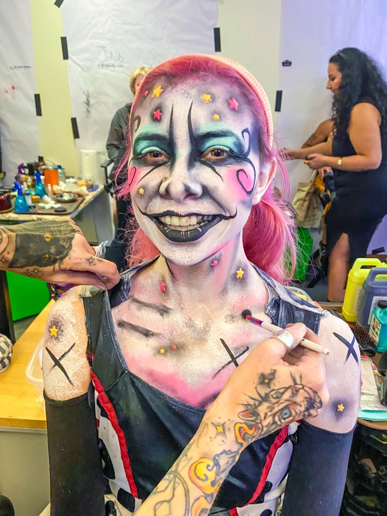 Emma Elizondo, who plays Jay, a demon nymph in the Carnival of Chaos, is ready to scare after the makeup artist finishes her look. (Photo by Thomas Melville/Beach & Bay Press)