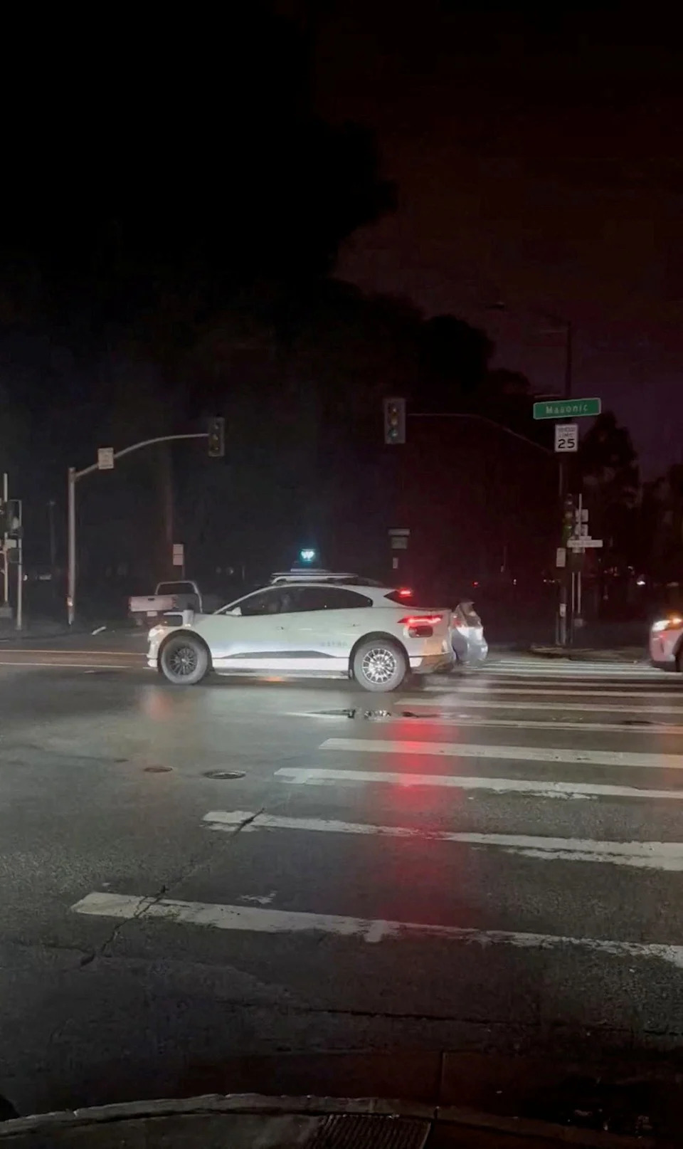 A Waymo car is halted on the road amid a power outage in San Francisco, California, U.S., December 20, 2025, in this screengrab obtained from a social media video.
