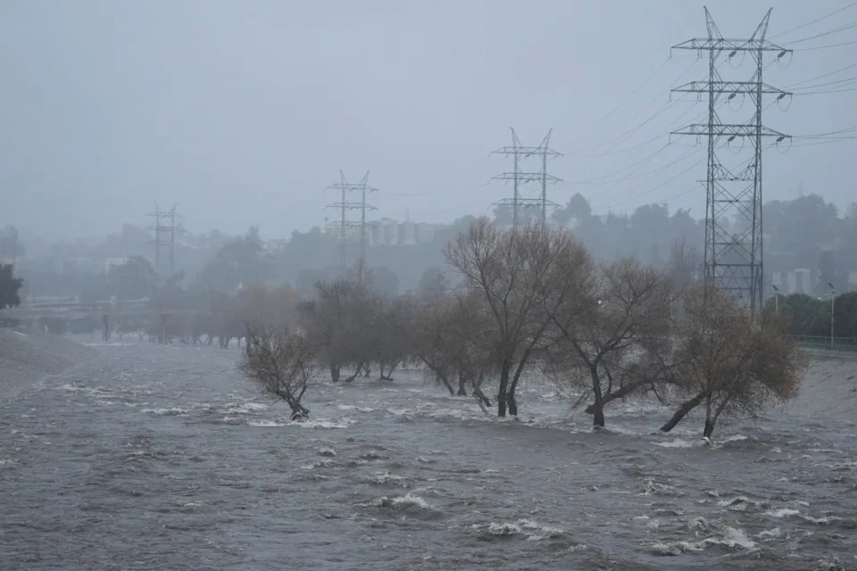 The Los Angeles River carries increased stormwater flow due to the atmospheric rivers affecting Northern California, which are expected to bring heavy rain and potential flooding to the Los Angeles area, Sunday, Feb. 4, 2024. (AP Photo/Damian Dovarganes)