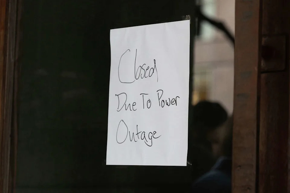 A sign rests during a power outage in San Francisco on Saturday. (Benjamin Fanjoy/For the S.F. Chronicle)