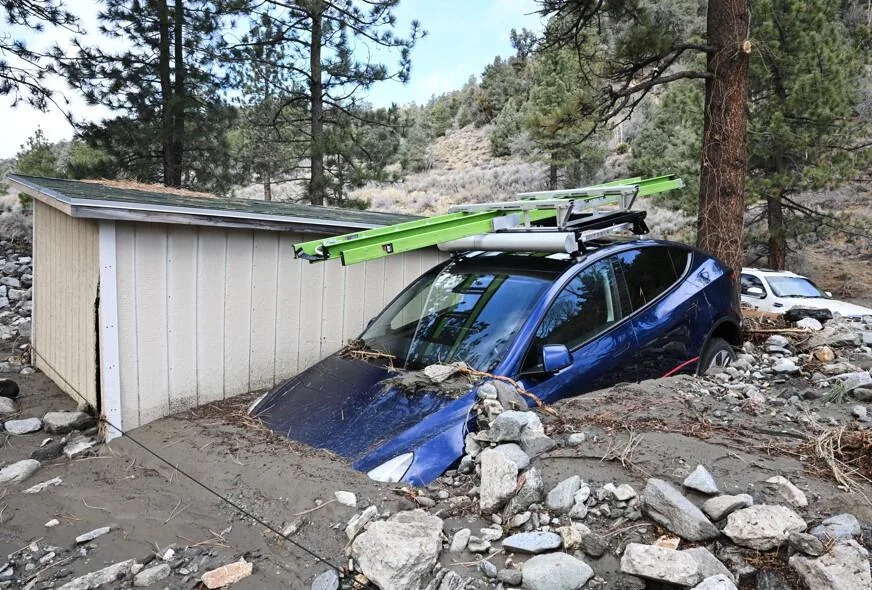 A car is buried in mud in Wrightwood, Calif. on Dec. 25, 2025 after a series of storms. / Credit: William Liang / AP