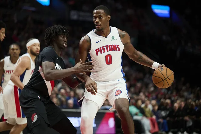 Dec 22, 2025; Portland, Oregon, USA; Detroit Pistons center Jalen Duren (0) dribbles the ball during the second half against Portland Trail Blazers guard Sidy Cissoko (91) at Moda Center.