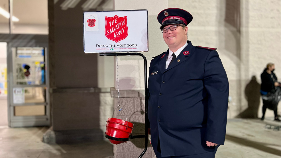 Captain Clint Trimmer with the Salvation Army poses for a photo next to the red kettle. Photo: KBAK/KBFX