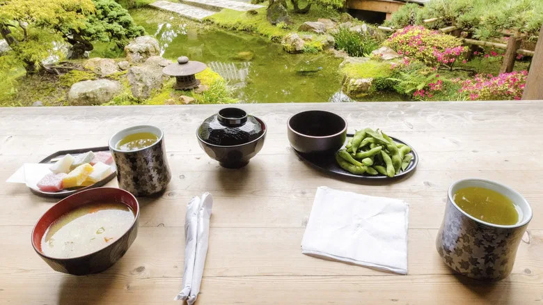 A table with green tea among gardens