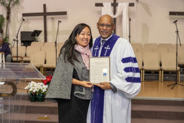 Sacramento City Councilmember Mai Vang presents Pastor Don F. Harris with a resolution. Russell Stiger Jr., OBSERVER