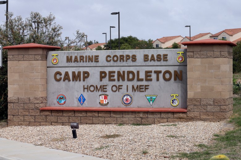 Sign for Marine Corps Base Camp Pendleton with military emblems.