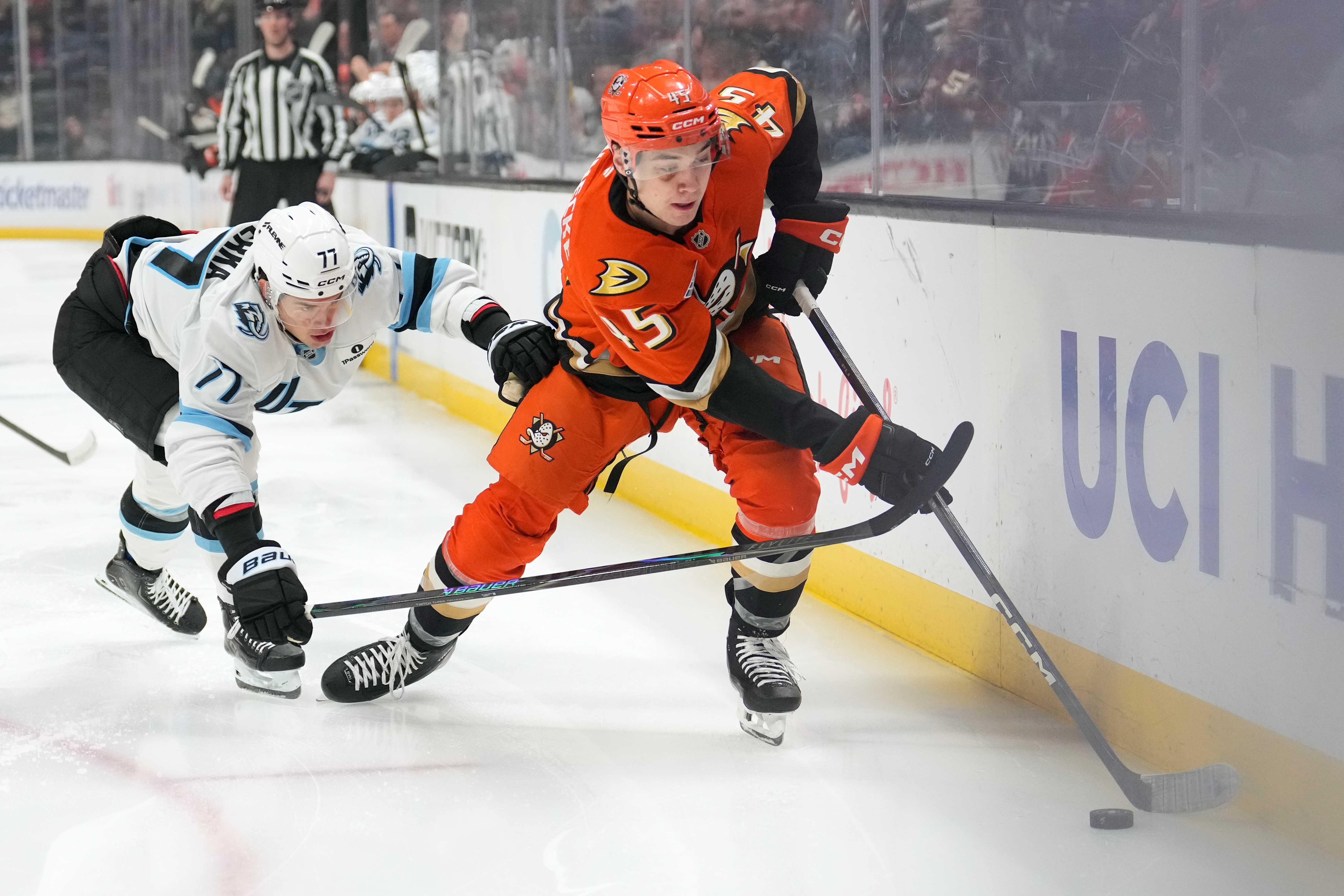 Utah Mammoth right wing JJ Peterka, left, reaches in on...