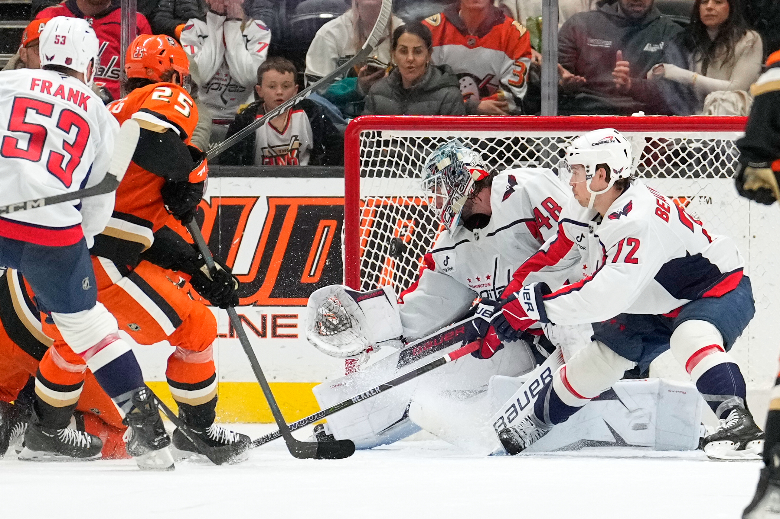 Washington Capitals goaltender Logan Thompson, second from right, is scored...