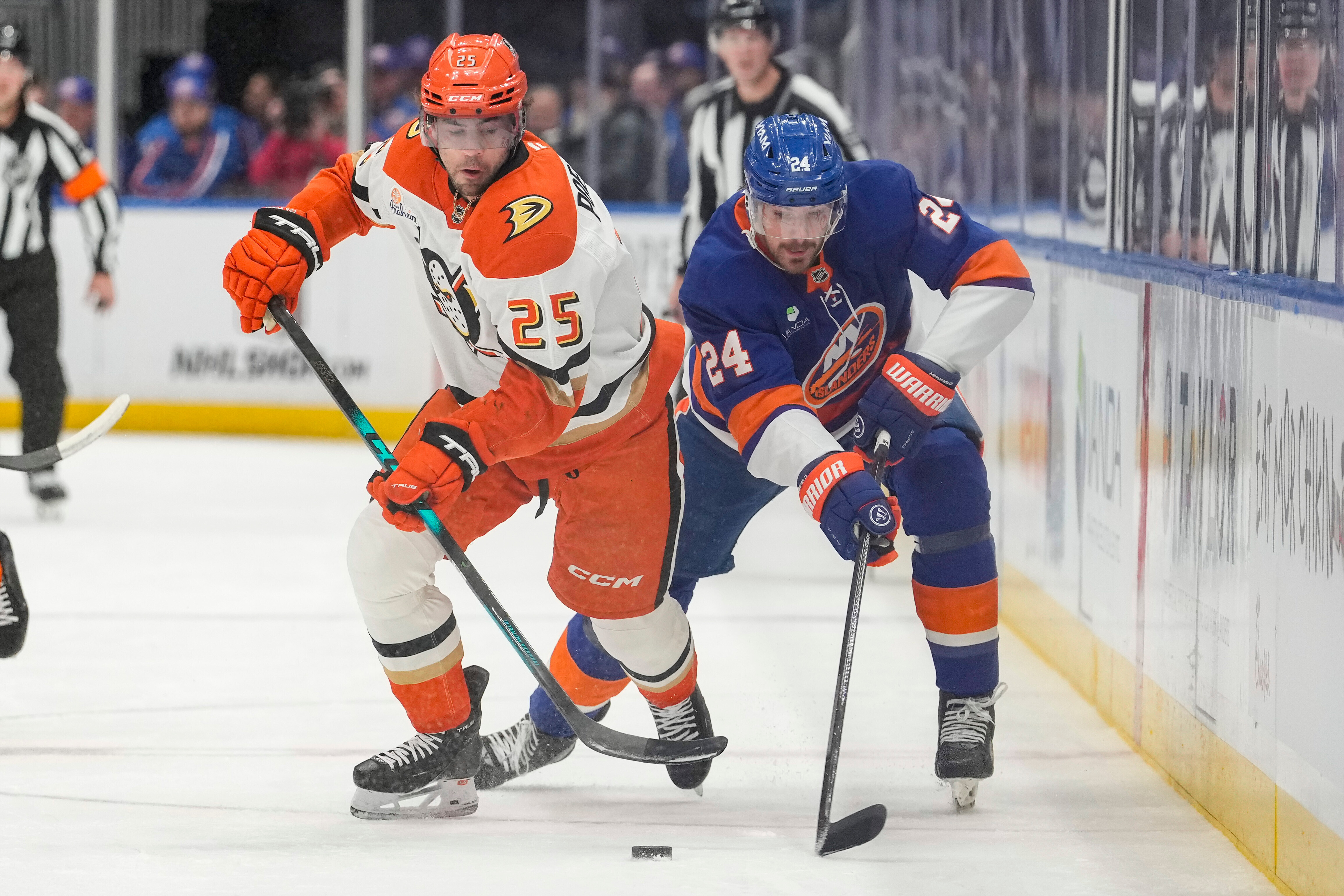 Ducks center Ryan Poehling, left, battles for control of the...