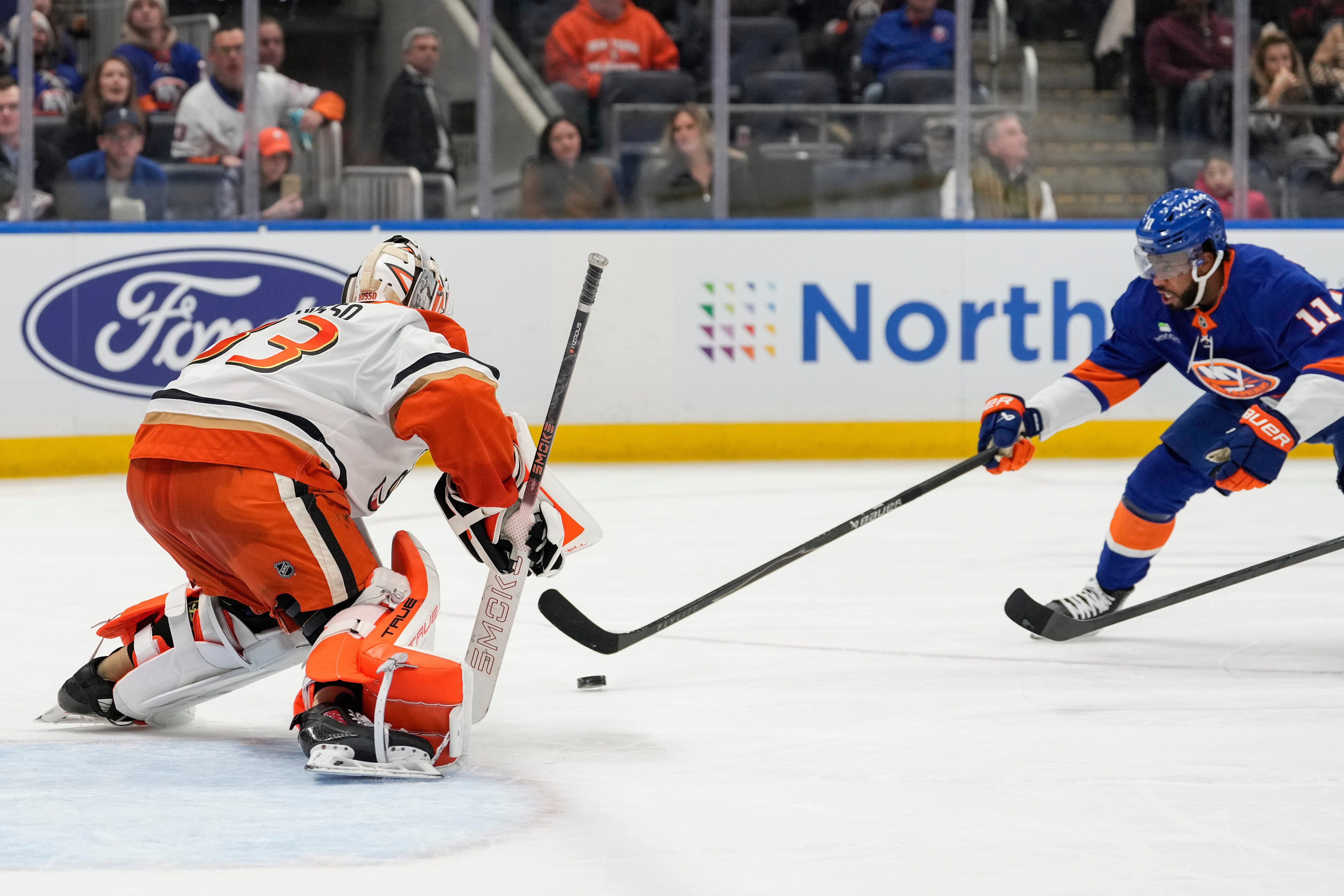 Ducks goaltender Ville Husso, left, protects his net from New...