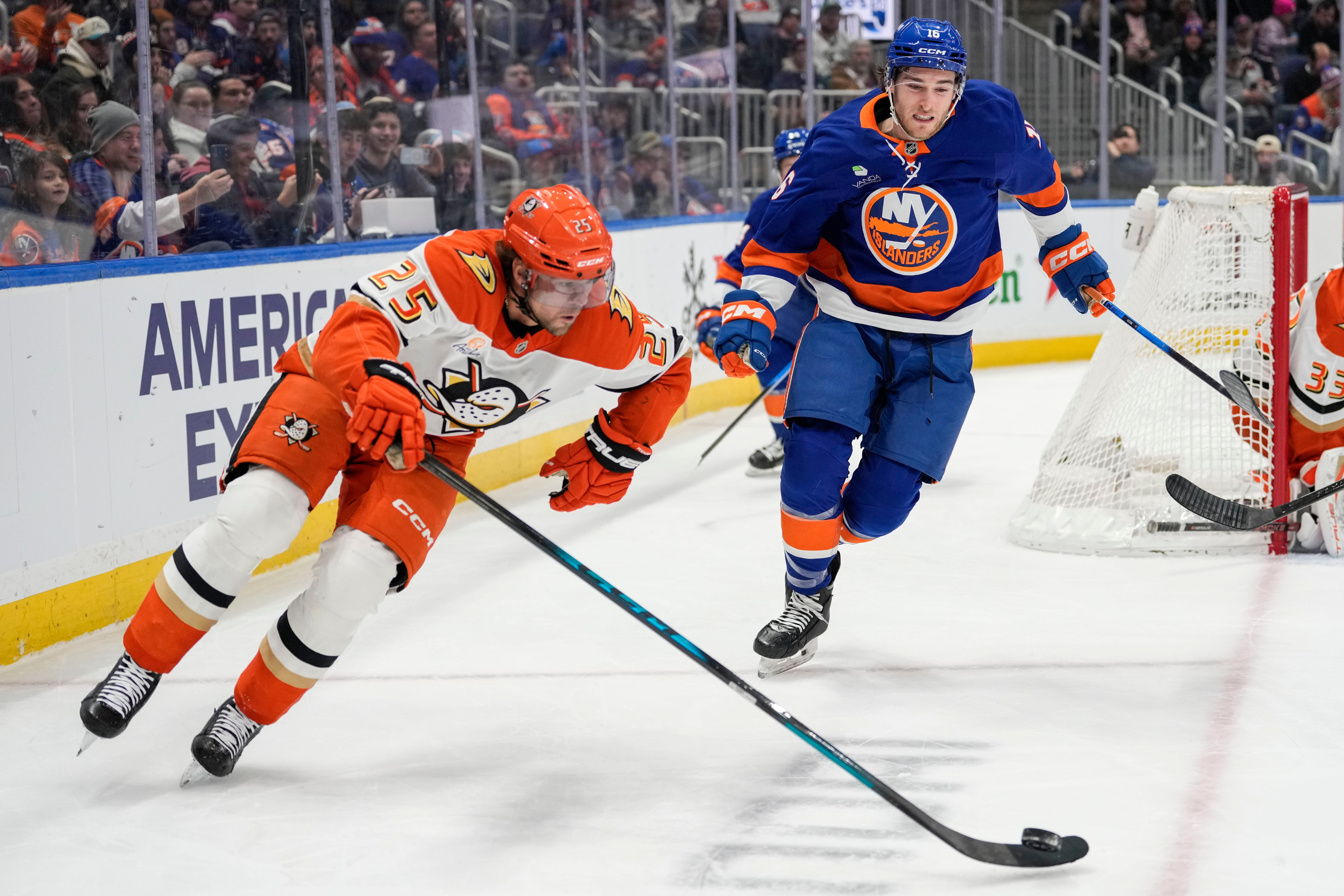Ducks center Ryan Poehling, left, controls the puck in front...