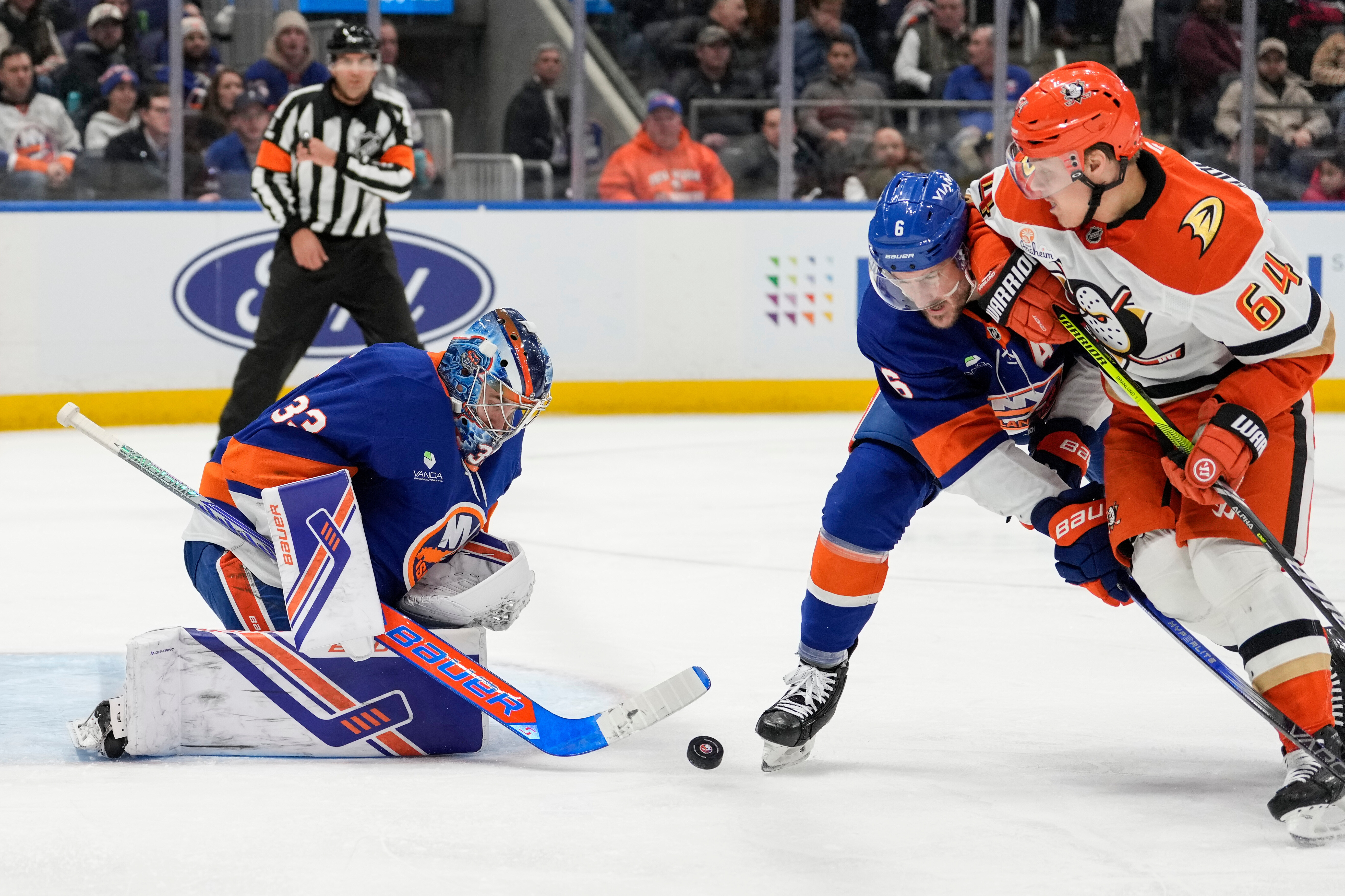 New York Islanders goaltender David Rittich, left, defends his net...