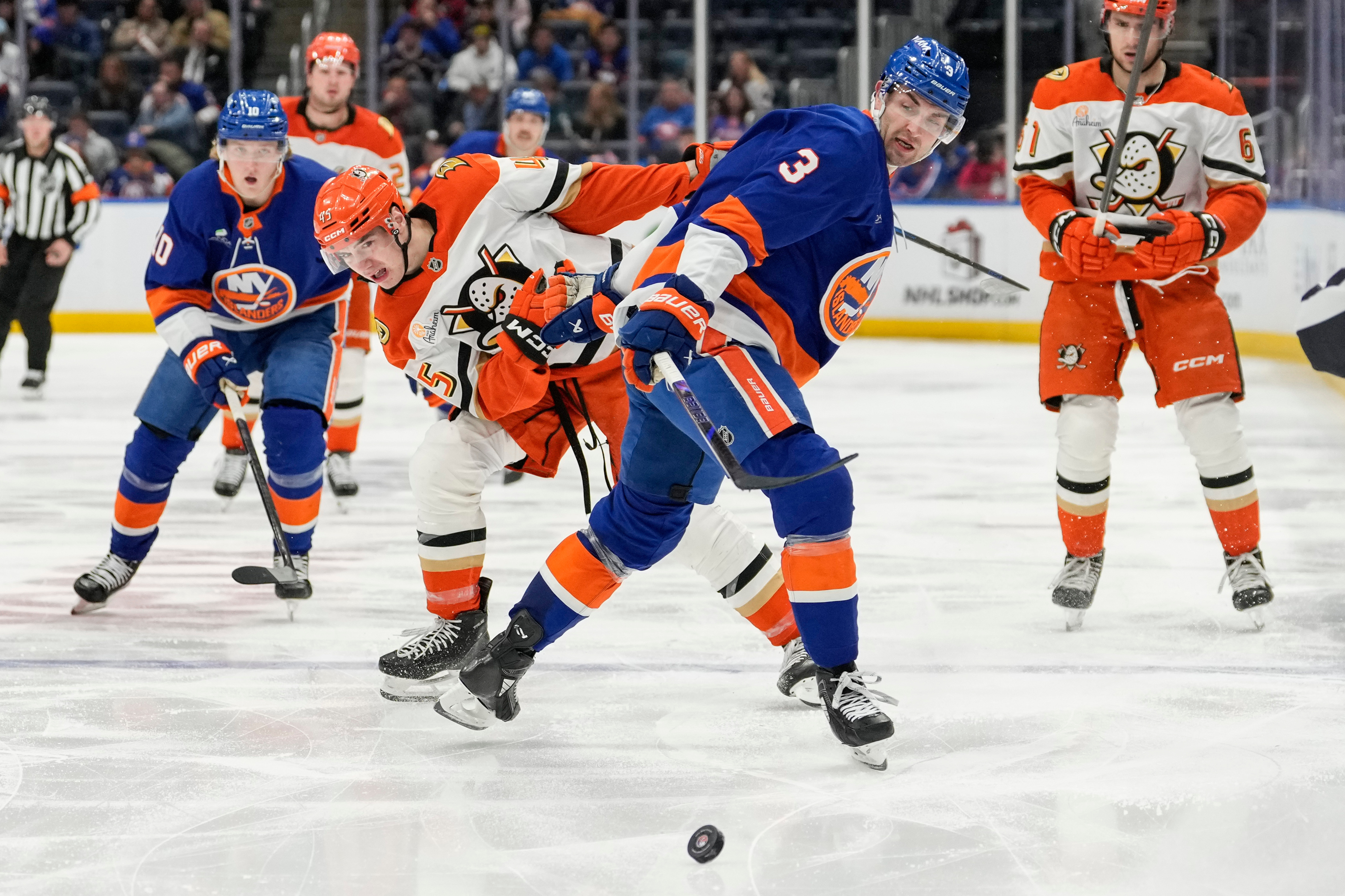 New York Islanders defenseman Adam Pelech (3) battles for control...