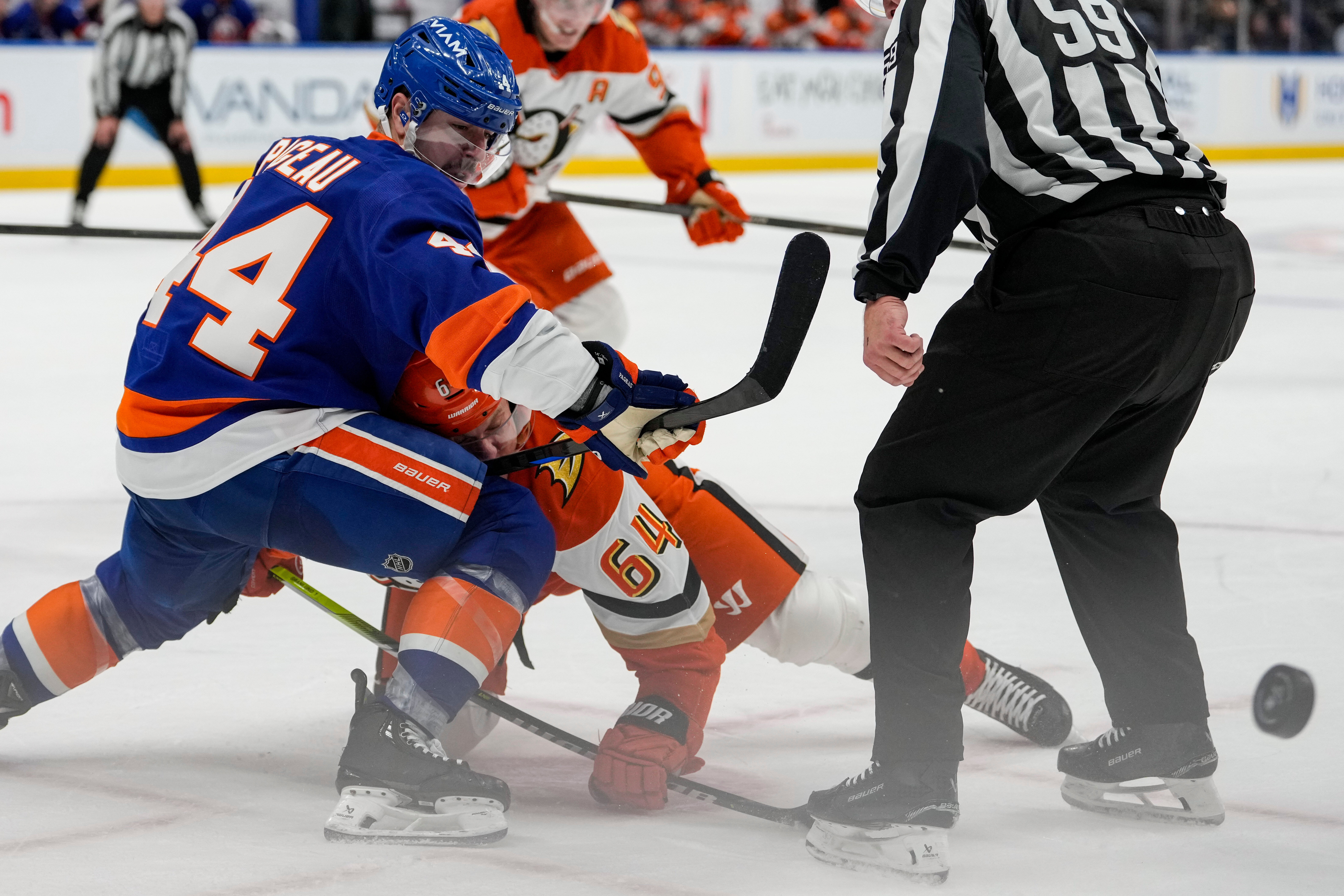 New York Islanders center Jean-Gabriel Pageau (44) fights for control...