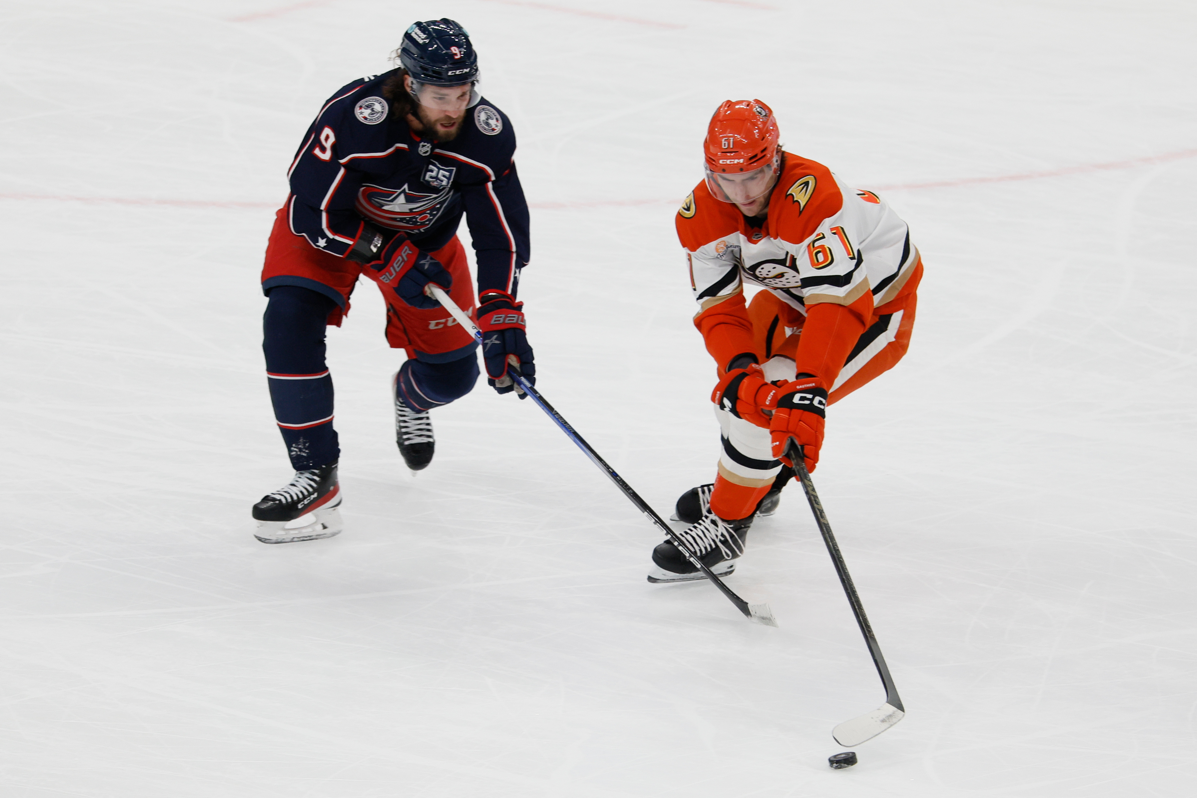 The Ducks’ Cutter Gauthier, right, keeps the puck away from...