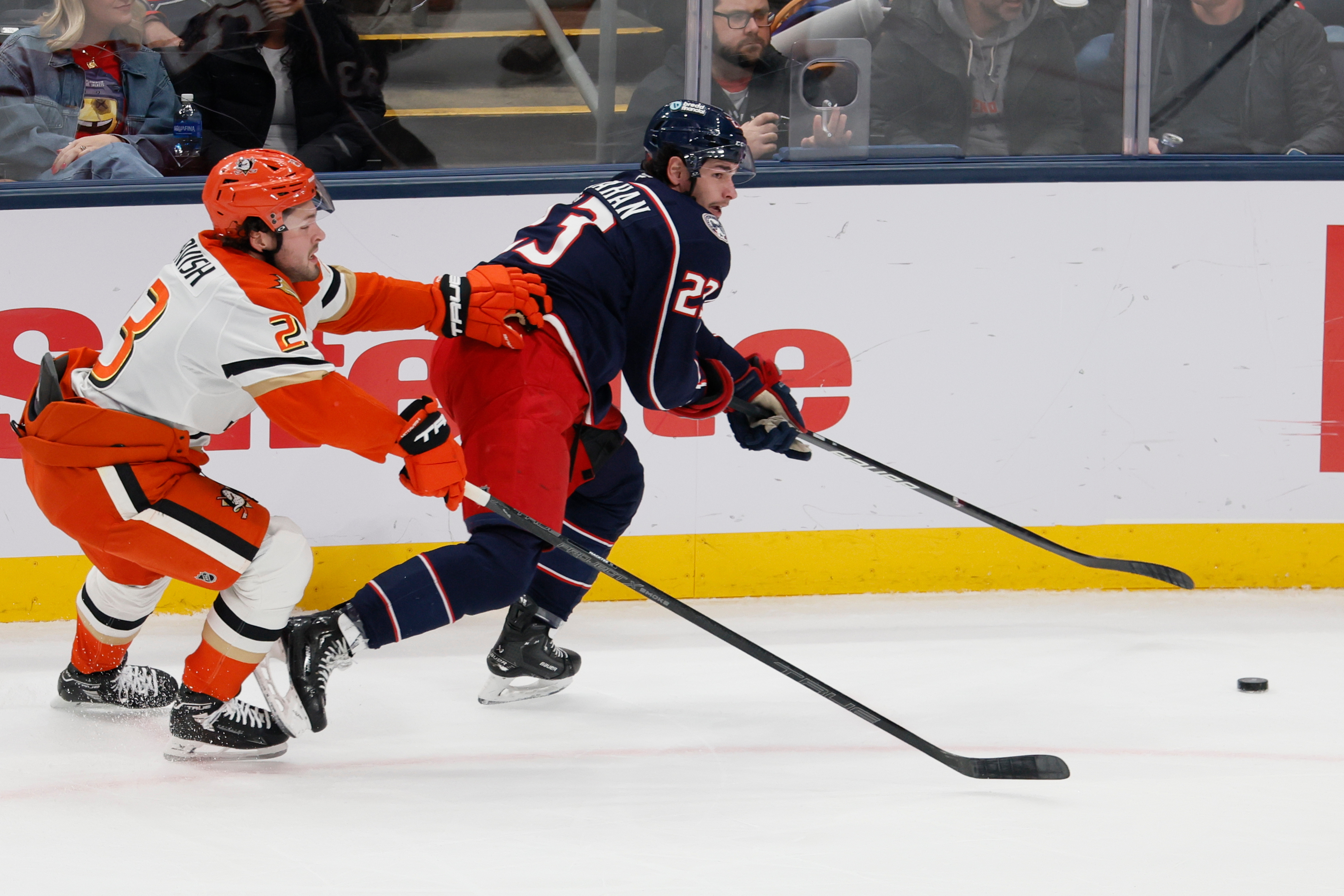 The Columbus Blue Jackets’ Sean Monahan, right, skates past the...