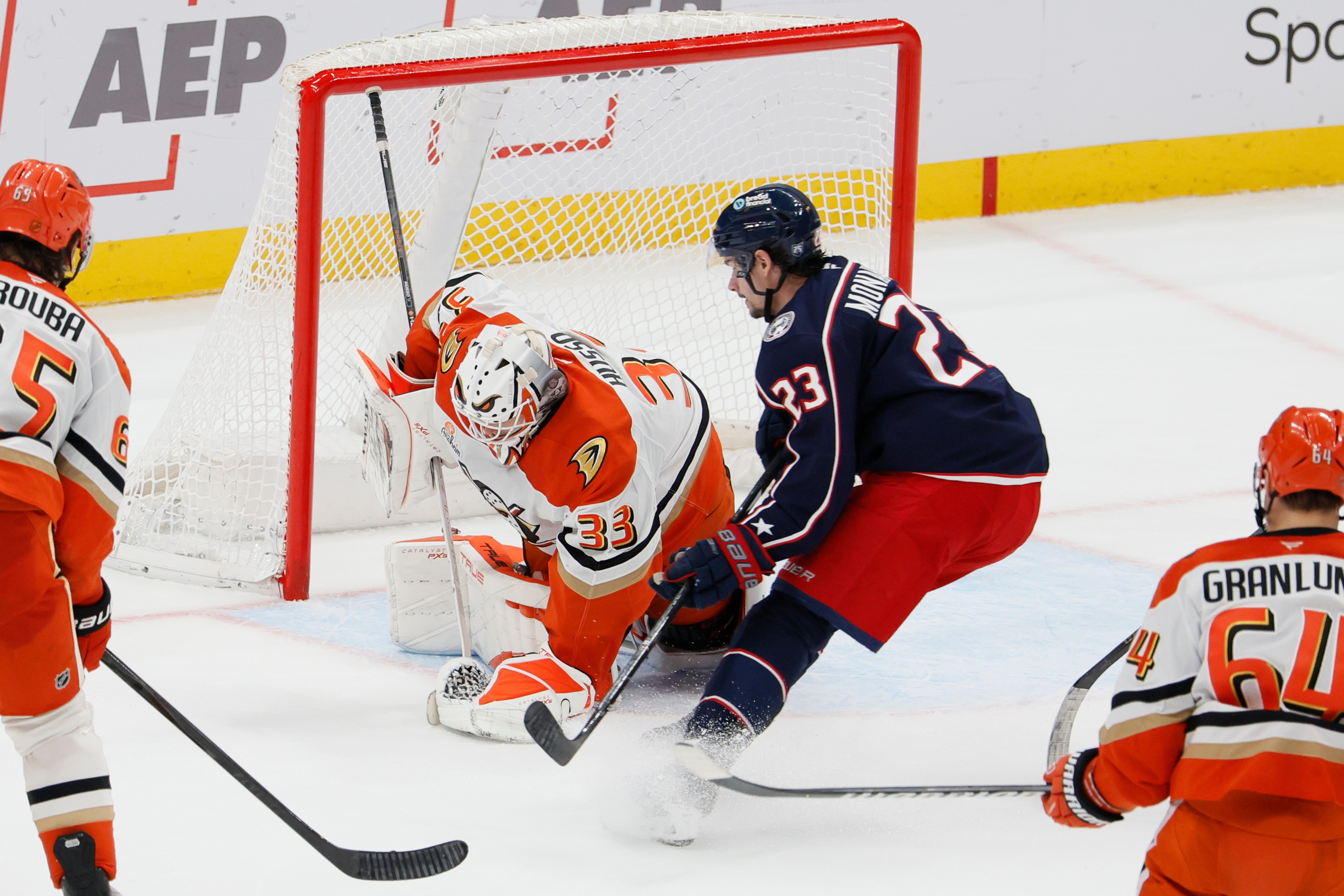 Ducks goaltender Ville Husso, left, makes a save against the...