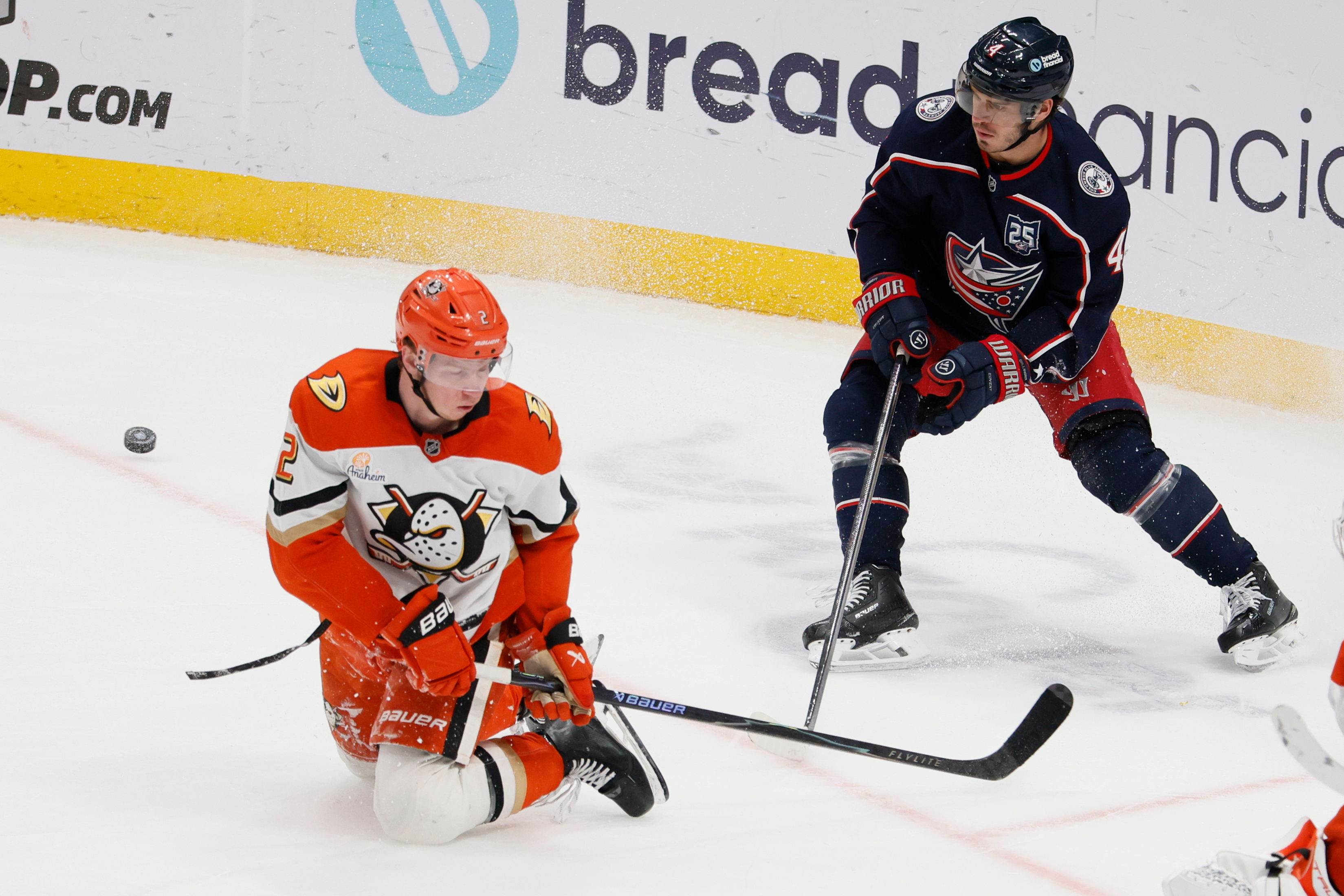 The Columbus Blue Jackets’ Cole Sillinger, right, passes the puck...