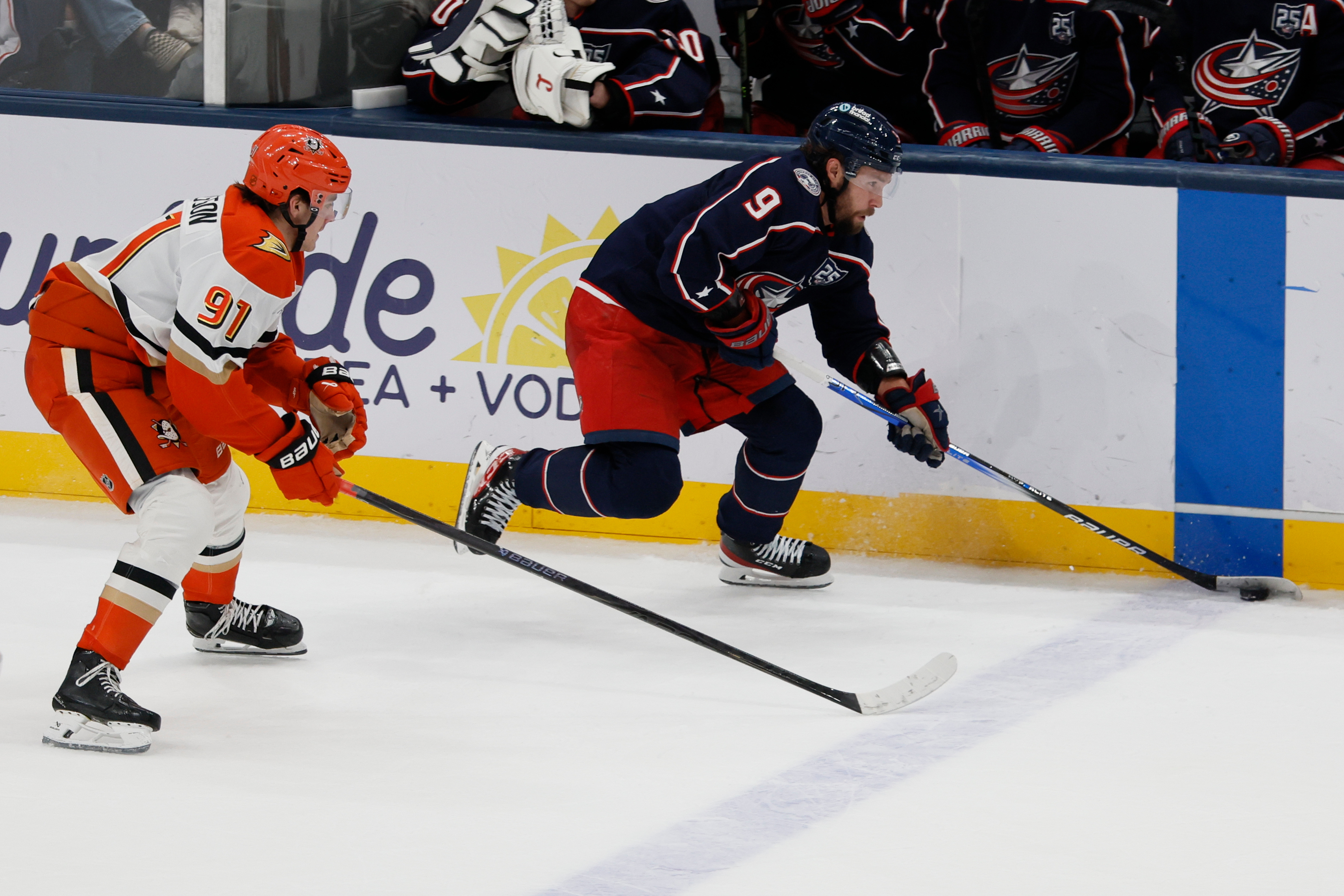 The Columbus Blue Jackets’ Ivan Provorov, right, carries the puck...