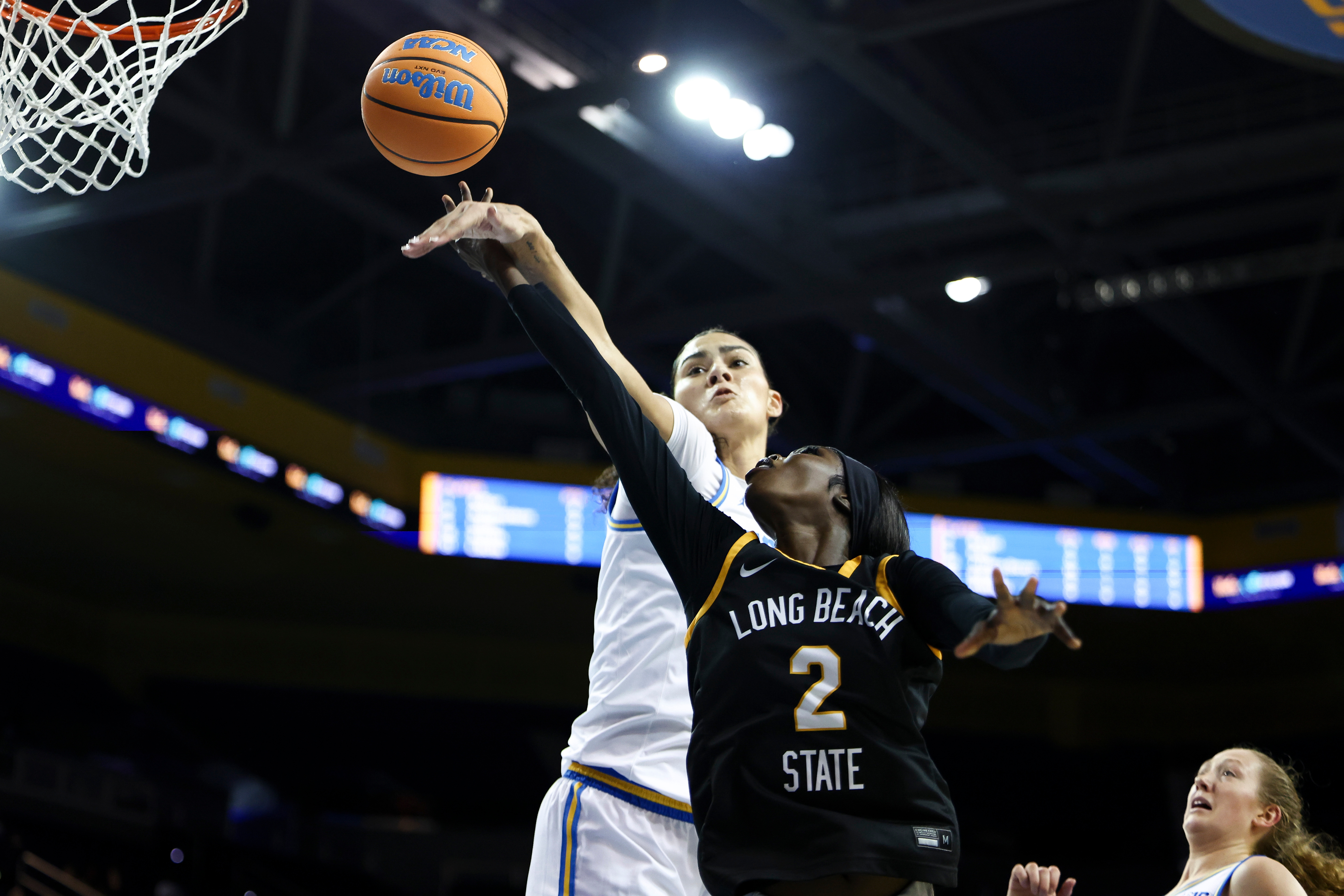 Long Beach State forward Rosie Akot (2) drives against UCLA...