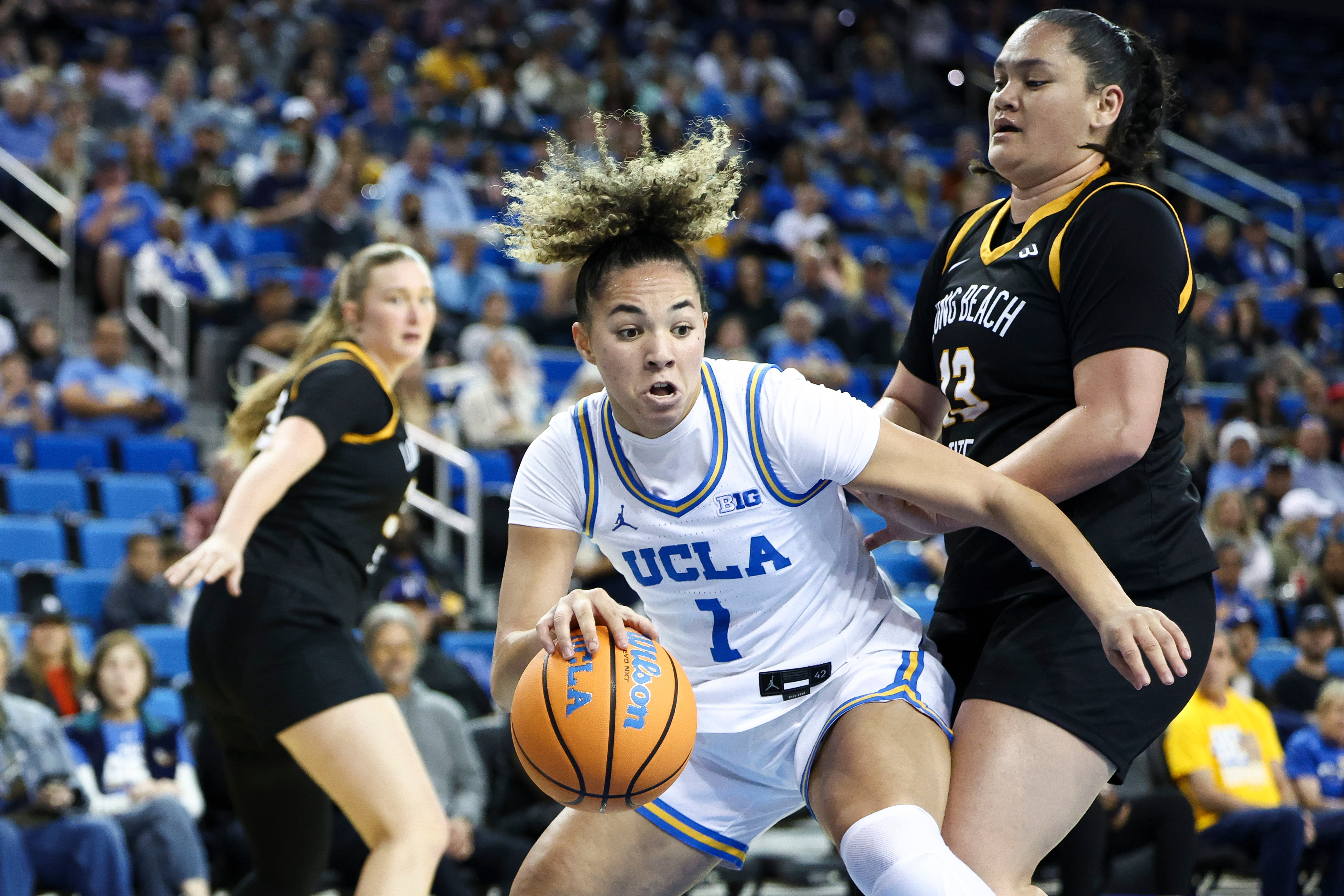 UCLA guard Kiki Rice drives as Long Beach State guard...