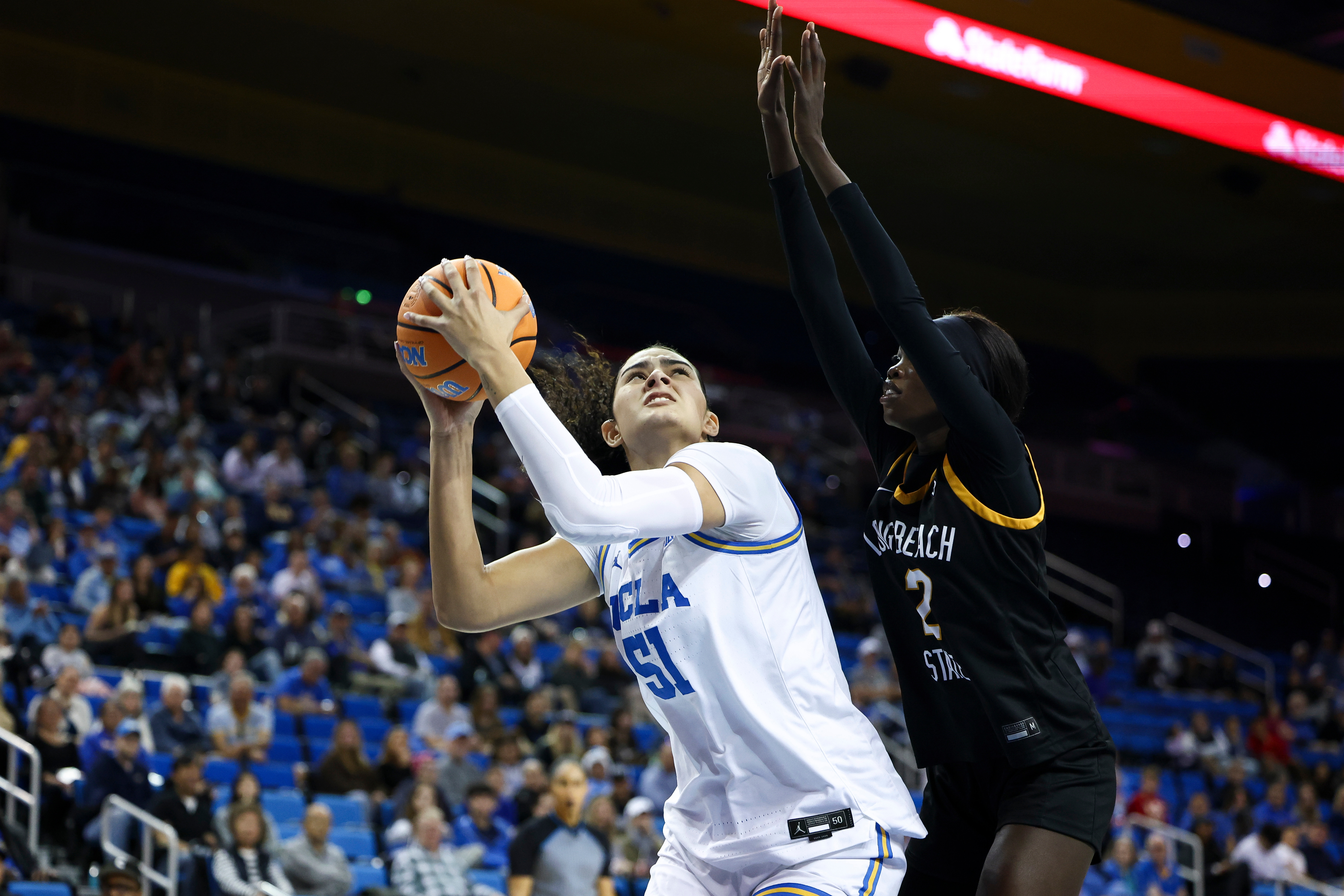UCLA center Lauren Betts (51) drives against Long Beach State...