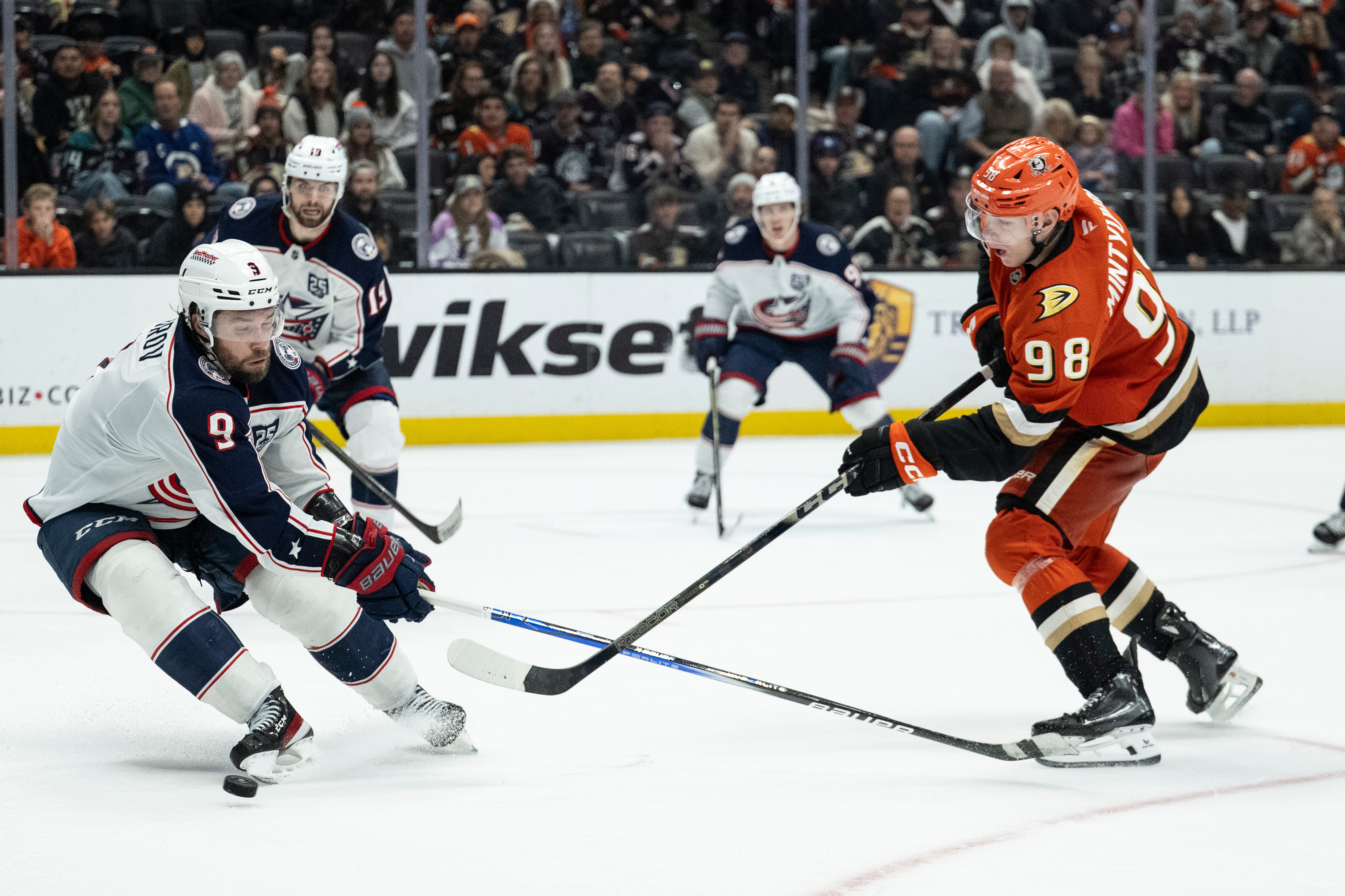 Ducks defenseman Pavel Mintyukov, right, shoots the puck as Columbus...