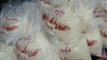 Bags of masa, a dough used to make tamales, are stacked on a counter at Amapola Market in Downey, Calif., Tuesday, Dec. 23, 2025. 
